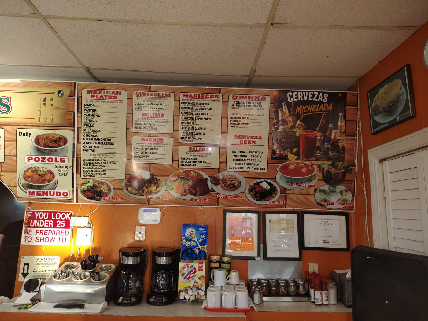 Menu boards on the orange wall inside Brito's
